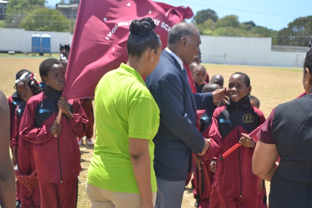 Premier of Nevis and Minister of Education Hon Vance Amory inspecting athletes with Marketing Manager of Gulf Insurance Ms. Lisa Hutson during the opening ceremony of the 24th Gulf Insurance Inter-Primary Schools Championship on March 30, 2016 at the Elquemedo T. Willet Park